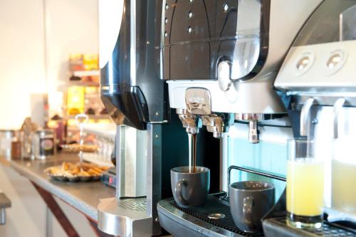 a coffee machine sitting on top of a counter at Sturup Airport Hotel in Malmö Sturup