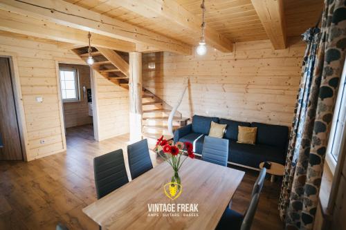 a living room with a table and a blue couch at Domki - Zajazd Zieleńska Polana in Wisła