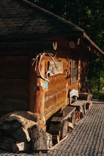 a log cabin with a window on the side of it at Domki - Zajazd Zieleńska Polana in Wisła