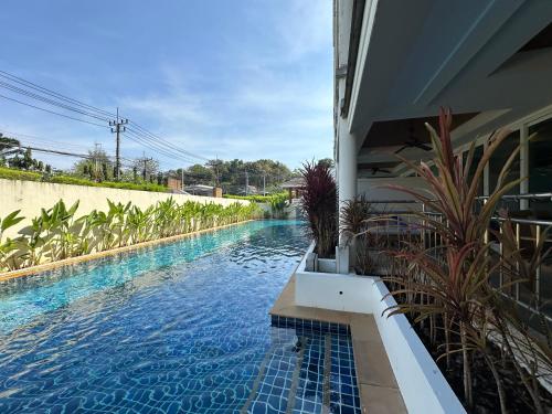 a swimming pool in the side of a house at Bel Air Cape Panwa resort apartment in south Phuket with pool access ,near Ao Yon in Phuket
