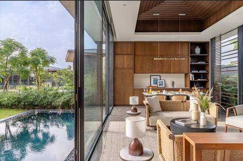 a living room with a swimming pool and a living room at MYSA Zinc Journey by The Fern, Nani Devati in Sānand