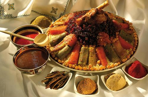 a table topped with a platter of vegetables and other spices at Rive Du Lac in Lalla Takerkoust