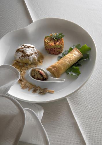 a white plate with food on a table at Rive Du Lac in Lalla Takerkoust