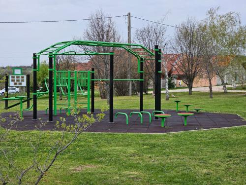 a park with benches and a playground at Zsonglak Vendégház in Kővágószőlős