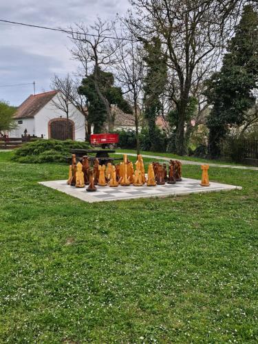 a group of yellow fire hydrants sitting on a table in the grass at Zsonglak Vendégház in Kővágószőlős