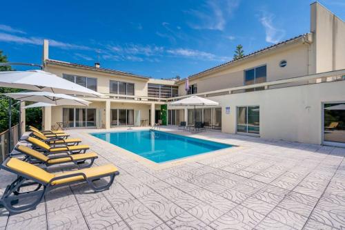 a house with a swimming pool and lounge chairs at Casa da Naia - by Proguest in Adaúfe