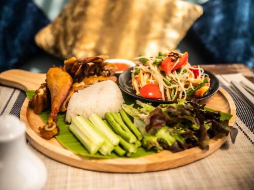a plate of food with vegetables on a table at Chantaramas Beach Resort Koh Phangan in Baan Khai