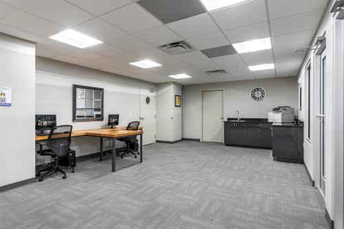 an office with a desk and chairs in a room at Modern Condo with Game Room in Downtown New Orleans in New Orleans