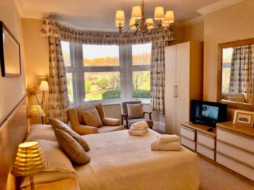 a bedroom with a large bed and a large window at White Acre in Scarborough