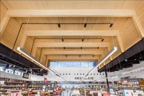 a view of a store with a large wooden ceiling at Stylish 2 Bedroom Haven by Jean Talon Market in Montréal