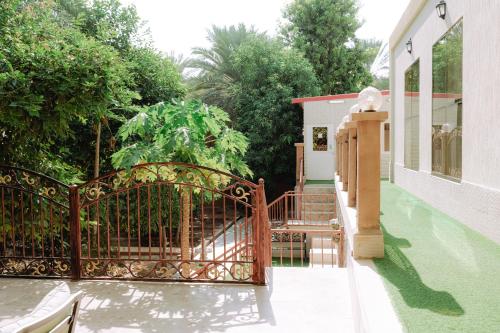 an entrance to a house with an iron gate at Hatta Orchard in Hatta
