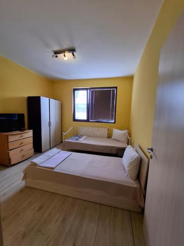 a bedroom with two beds and a window at LA Vie in Opanets
