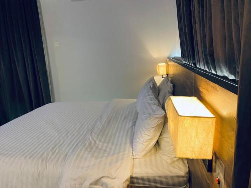 a bedroom with a bed next to a window at Sunset BnB Creek in Karachi
