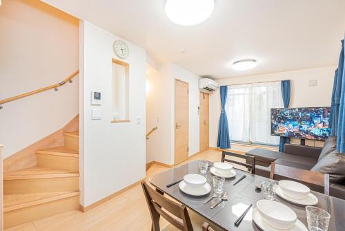 a dining room and living room with a table and chairs at Otsuka house with 3BR near the Yamanote line in Tokyo