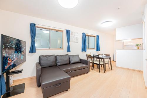 a living room with a couch and a table at Otsuka house with 3BR near the Yamanote line in Tokyo