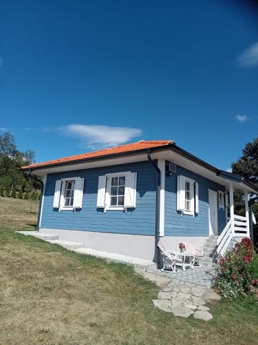 a blue house with a bench in front of it at Vikendica Maša Blu in Šljivovica