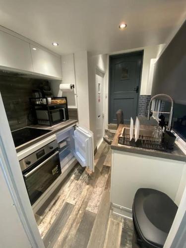 a kitchen with a sink and a toilet in it at Studio 49 home from home in Birmingham