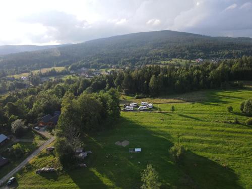 an aerial view of a green field with trees at Domek na Groniku in Zubrzyca Górna
