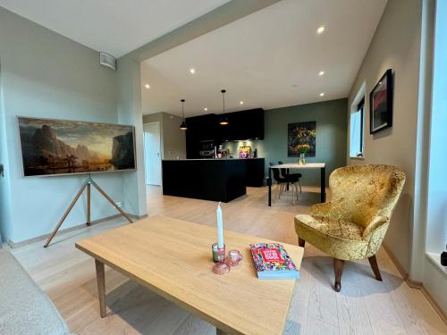a living room with a table and a chair at Central apartment in Tromsø