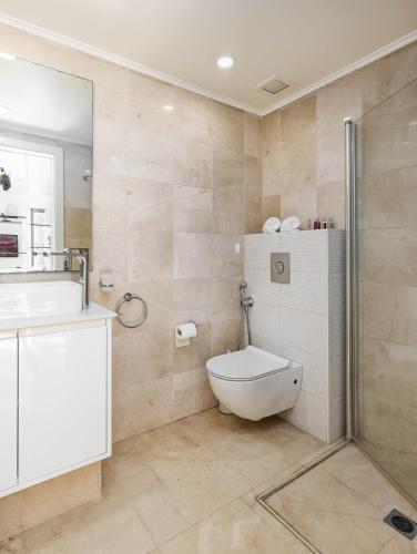 a bathroom with a toilet and a sink and a shower at Marina view 2bd Luxury Ap in Herzliya B