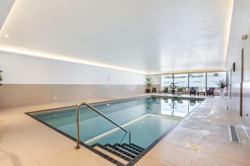 a large swimming pool in a building with a swimming pool at 8 Middlecombe - Luxury Apartment at Byron Woolacombe, only 4 minute walk to Woolacombe Beach! in Woolacombe