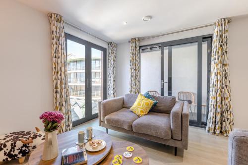 a living room with a couch and a table at 8 Middlecombe - Luxury Apartment at Byron Woolacombe, only 4 minute walk to Woolacombe Beach! in Woolacombe