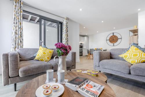 a living room with two couches and a coffee table at 8 Middlecombe - Luxury Apartment at Byron Woolacombe, only 4 minute walk to Woolacombe Beach! in Woolacombe