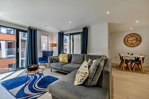 a living room with a couch and a table at Byron - Luxury Self-Catering Coastal Apartment at the Heart of Woolacombe with Heated Indoor Pool & Gym - 4 Minutes Walk to Beach! 6 Middlecombe in Woolacombe
