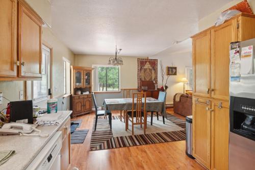 a kitchen with a table and a dining room at Secluded Mountain Cabin with Forest Views cabin in Happy Jack