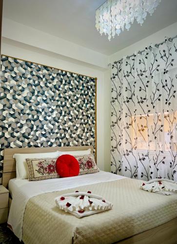 a bedroom with a large bed with a red pillow at Venice VIP Guest House in Mestre