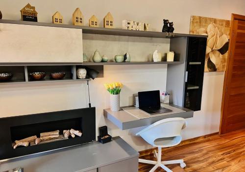 a room with a desk with a laptop and a chair at Cozy Apartment in South Malta in Fgura