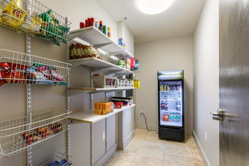 a walk in pantry with shelves and a refrigerator at Tasteful Condo Walking Distance to French Quarter in New Orleans