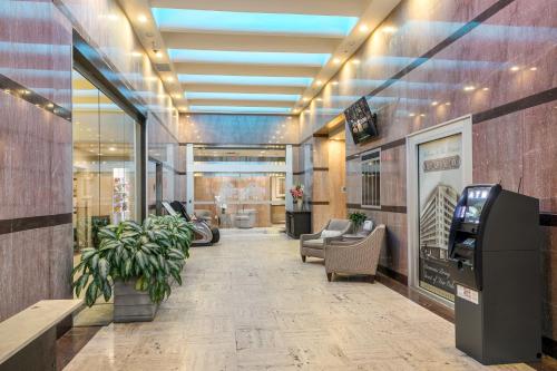 a lobby with a waiting area with chairs and a cash register at Tasteful Condo Walking Distance to French Quarter in New Orleans