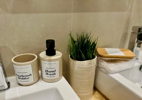 two bottles of handcrafted market on a sink in a bathroom at Cozy Apartment in South Malta in Fgura