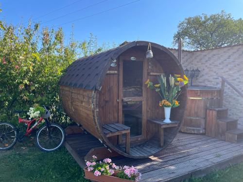a wooden gazebo on a deck with a bike at Casa Dudu in Moieciu de Jos