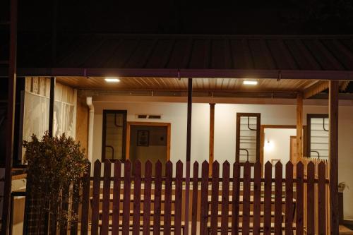 a house with a wooden fence in front of it at Marari Bobans villa in Mararikulam