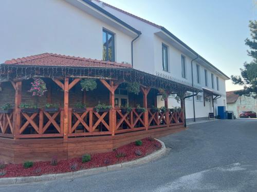 a building with a wooden fence in front of it at Vrbecká restaurace - penzion 8 in Hrubá Vrbka