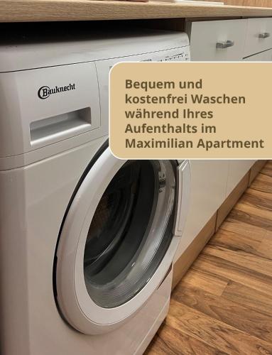 a washing machine in a kitchen with a sign that reads between androstetter washing at Haus Waldblick in Philippsreut