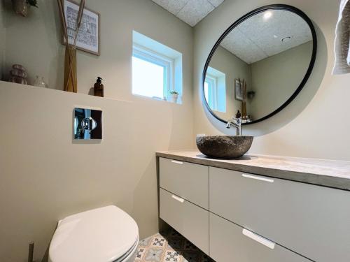a bathroom with a sink and a mirror at Stunning 3 Bedroom Family Friendly Retreat in Tvøroyri