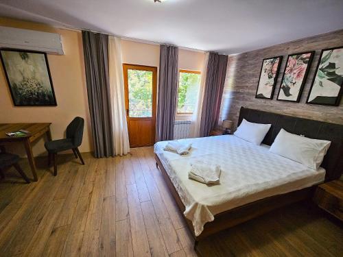 a bedroom with a bed and a table and a desk at Alen Mak Forest Hotel in Lipnik