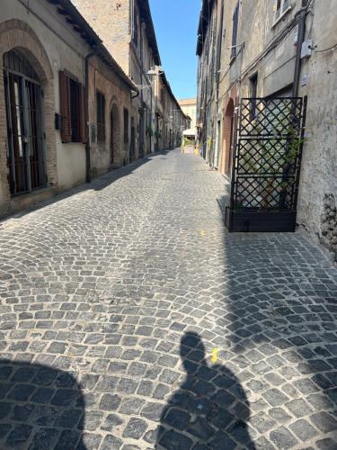 a shadow of a person walking down a street at Casa gioia in Bracciano