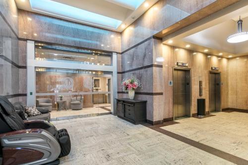 a lobby of a salon with a flower vase at Urban Living in the Heart of New Orleans in New Orleans