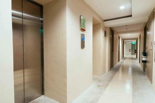 a hallway of a building with a corridorngthngthngthngthngthngthngthngth at Urban Deca Tower OYO in Manila