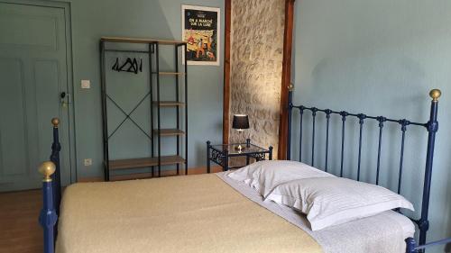 a bedroom with a bed and a book shelf at Le Pressoir de Marsac in Marsac