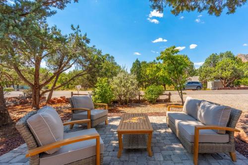 a group of chairs and a coffee table on a patio at Amethyst Retreat. Back Yard with Hot Tub & Views! in Sedona
