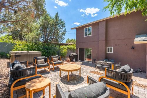 a patio with chairs and tables and a grill at Amethyst Retreat. Back Yard with Hot Tub & Views! in Sedona