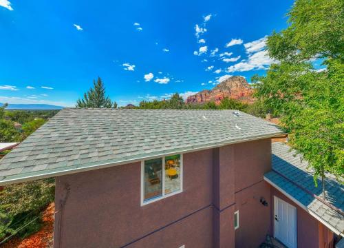 a house with a mountain in the background at Amethyst Retreat. Back Yard with Hot Tub & Views! in Sedona