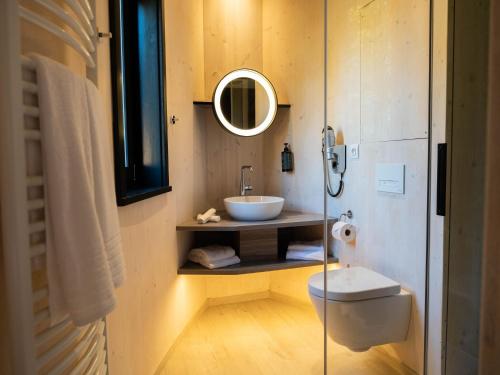 a bathroom with a sink and a toilet and a mirror at The Brookside Escape in Antoing
