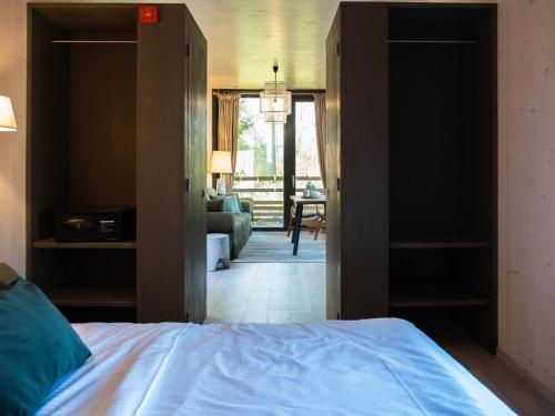 a bedroom with a bed and a living room at The Brookside Escape in Antoing