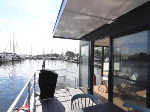 a boat deck with a view of a marina at Houseboat in Lemmer with Harbor Views in Lemmer